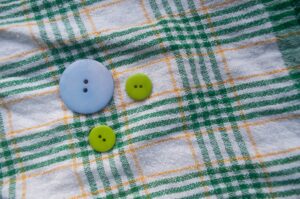 3 buttons on a checkered textile